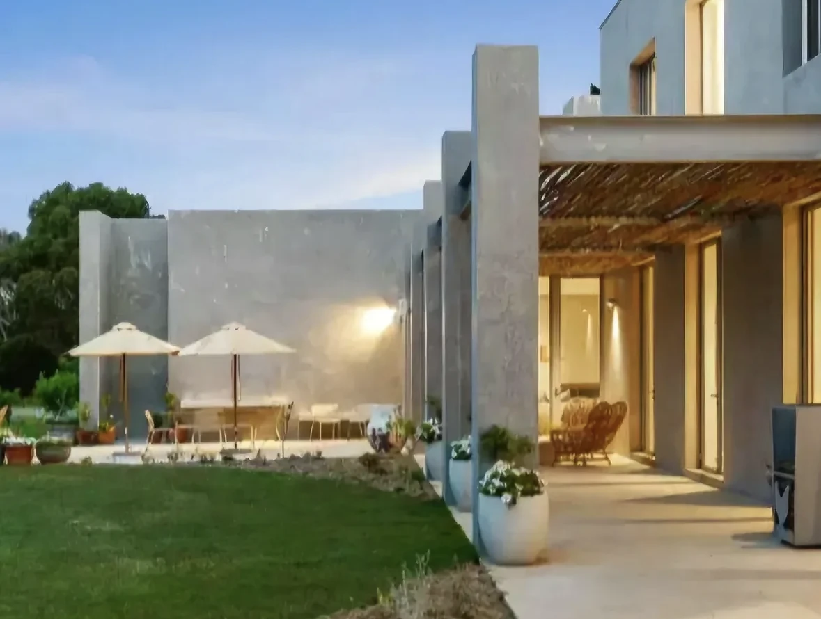 The painted exterior and garden terrace at the Jan Juc home