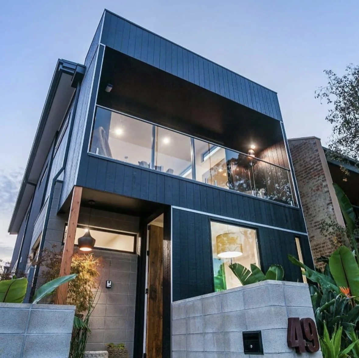 Dark blue painted cladding and timber details on a Newport home